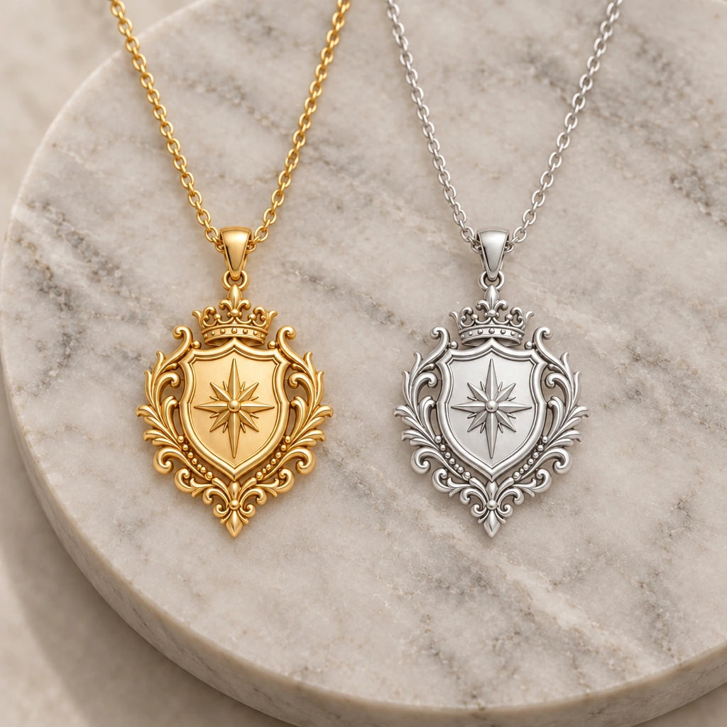 Noble Crest Compass Shield pendant necklace in silver and gold finishes side by side