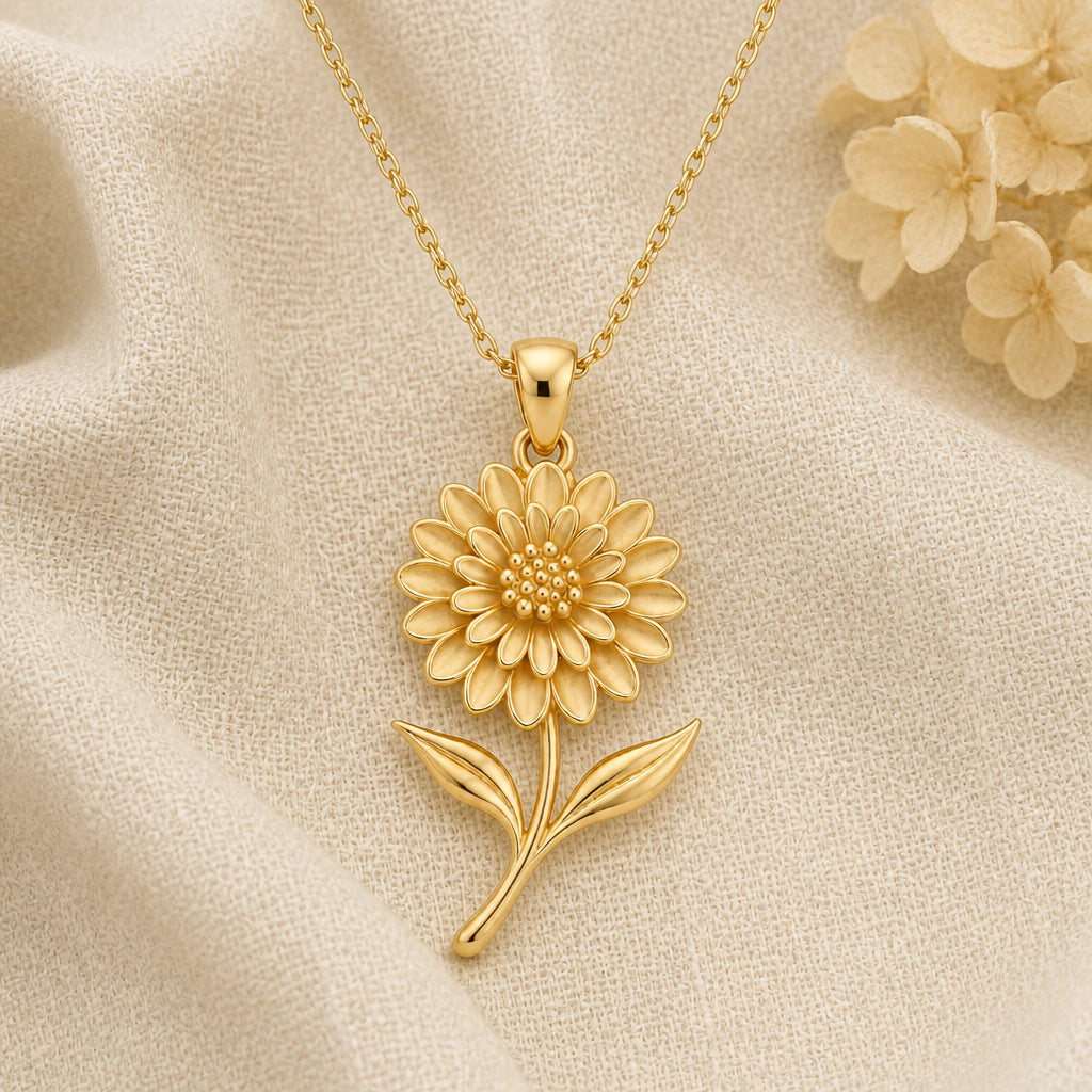 Dahlia Flower pendant necklace in a warm gold finish on cream fabric