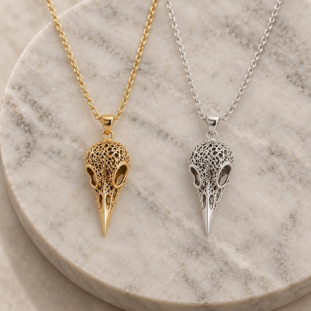 Raven Skull Relic pendant necklace in silver and gold finishes side by side