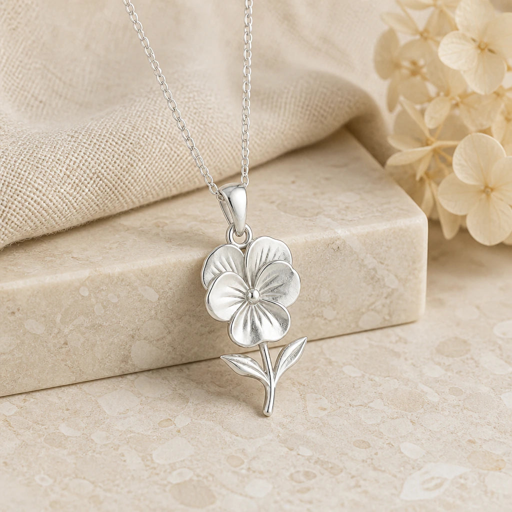 925 sterling silver pansy flower pendant necklace on softly folded cream linen