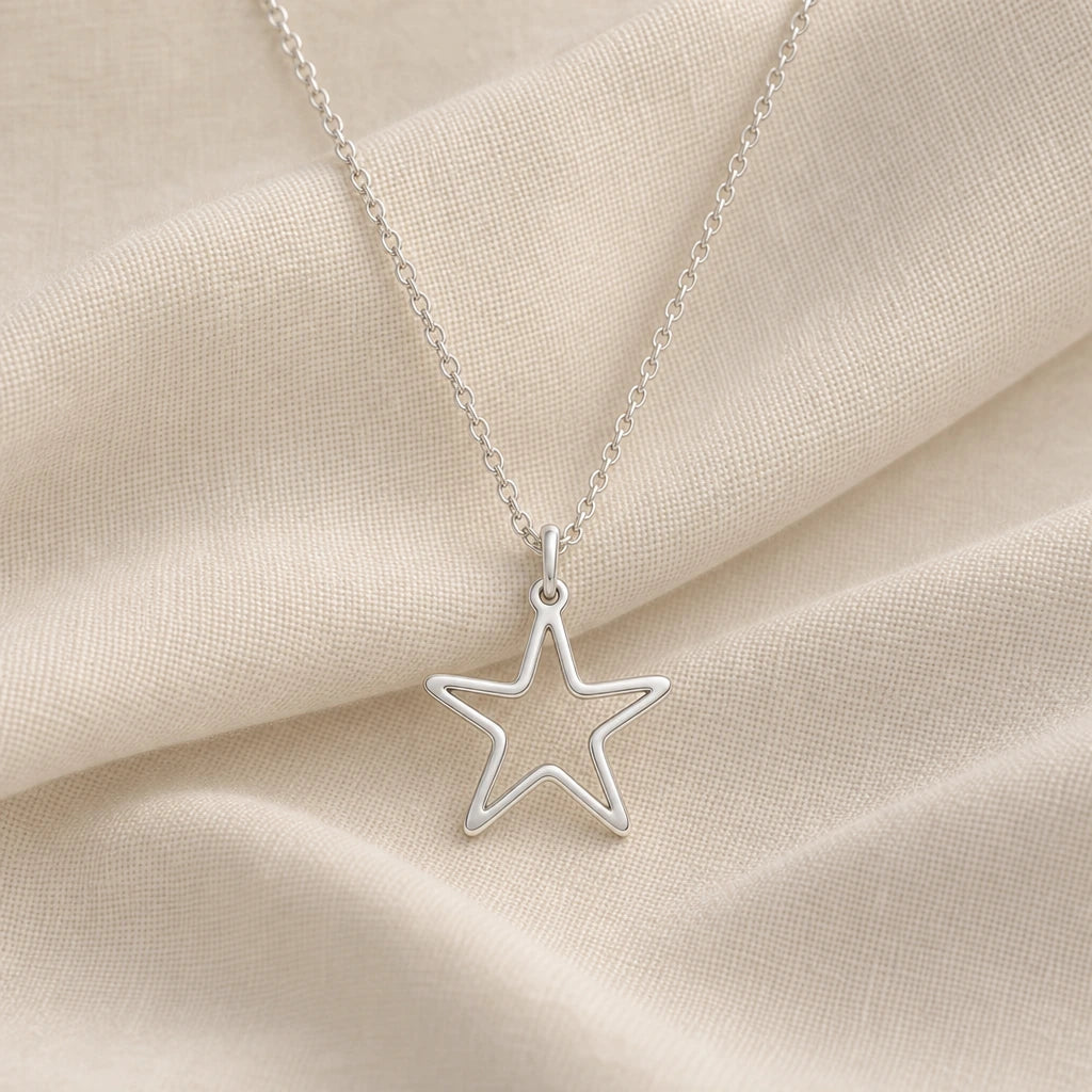 925 sterling silver starfish outline pendant necklace on cream fabric