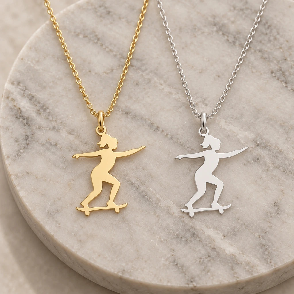Skateboard Girl pendant necklace in silver and gold finishes side by side
