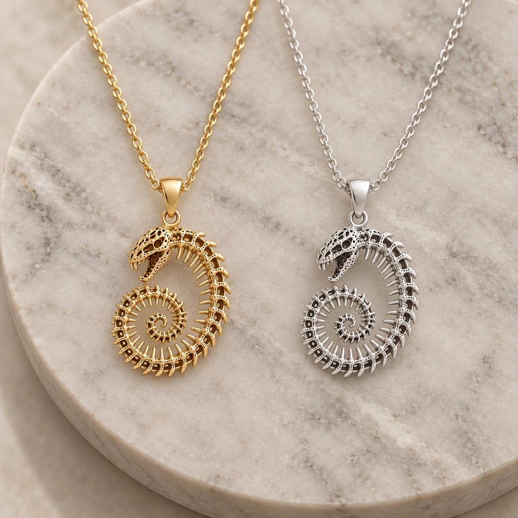 Fossil Cobra Skeleton Spiral pendant necklace in silver and gold finishes side by side