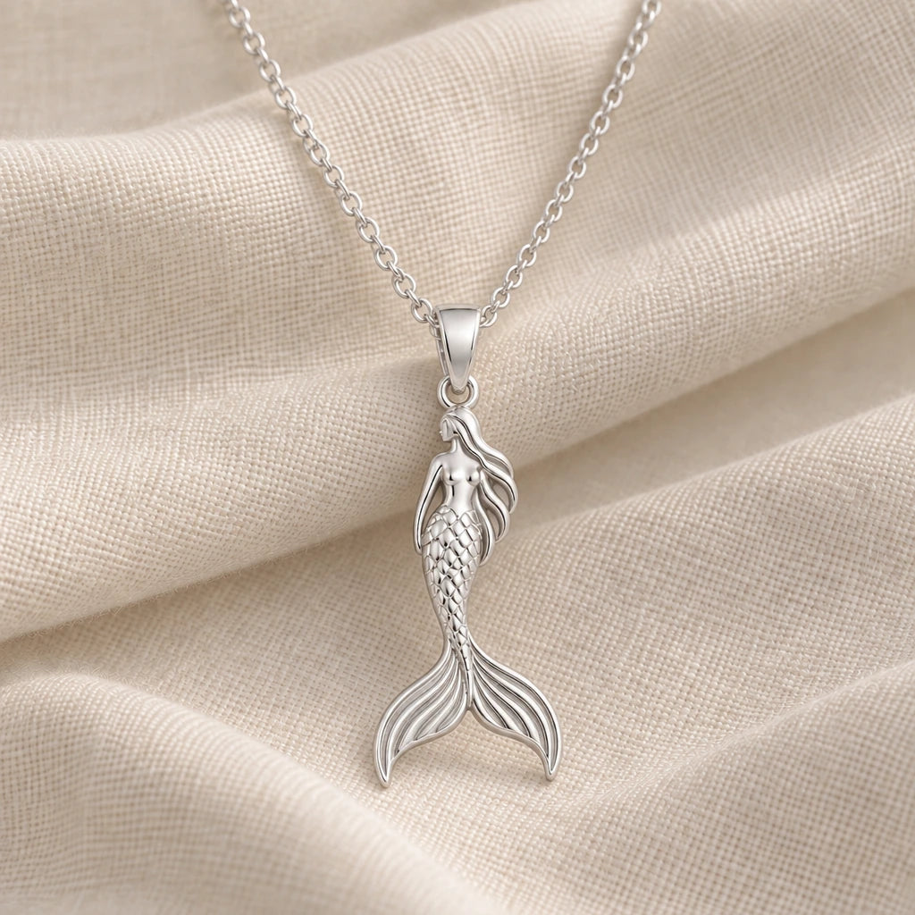 925 sterling silver mermaid figure pendant necklace on cream fabric