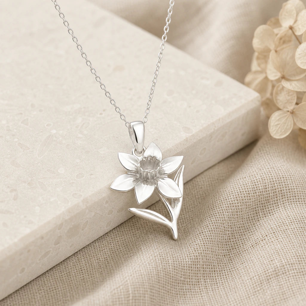 925 sterling silver daffodil narcissus flower pendant necklace on softly folded cream linen