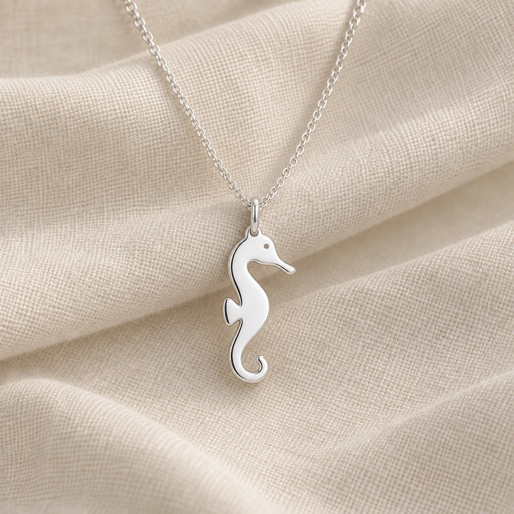 925 sterling silver seahorse silhouette pendant necklace on cream fabric