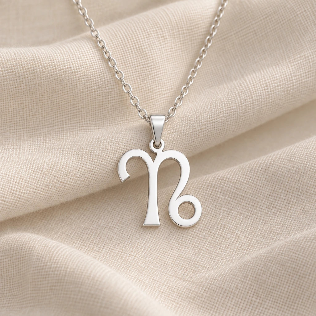 925 sterling silver capricorn zodiac glyph pendant necklace on cream fabric