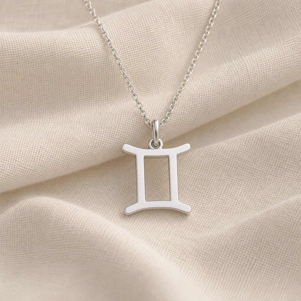 925 sterling silver gemini zodiac glyph pendant necklace on cream fabric
