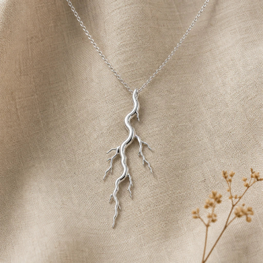 Close-up of silver lightning bolt pendant with branching forks