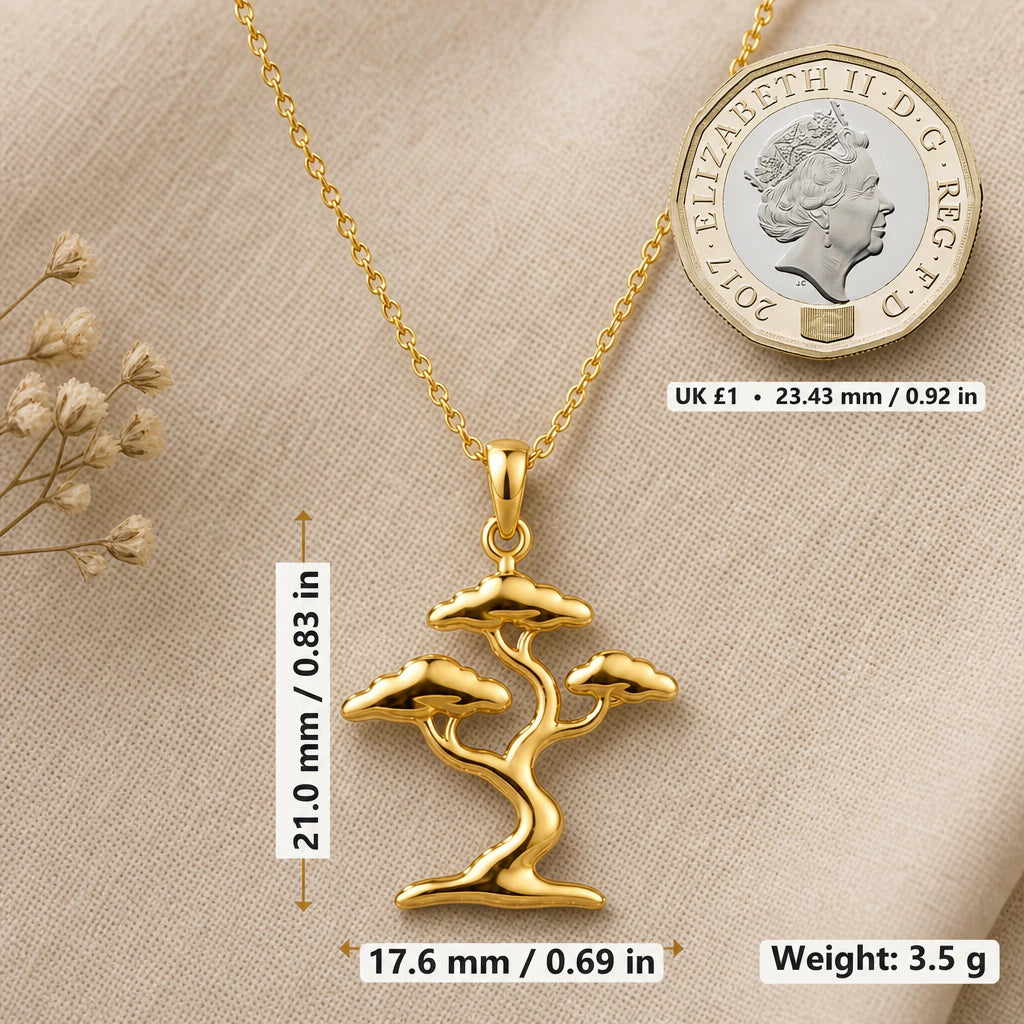 Bonsai tree necklace size image showing 21 mm height, 17.6 mm width and 3.5 g weight beside a UK pound coin