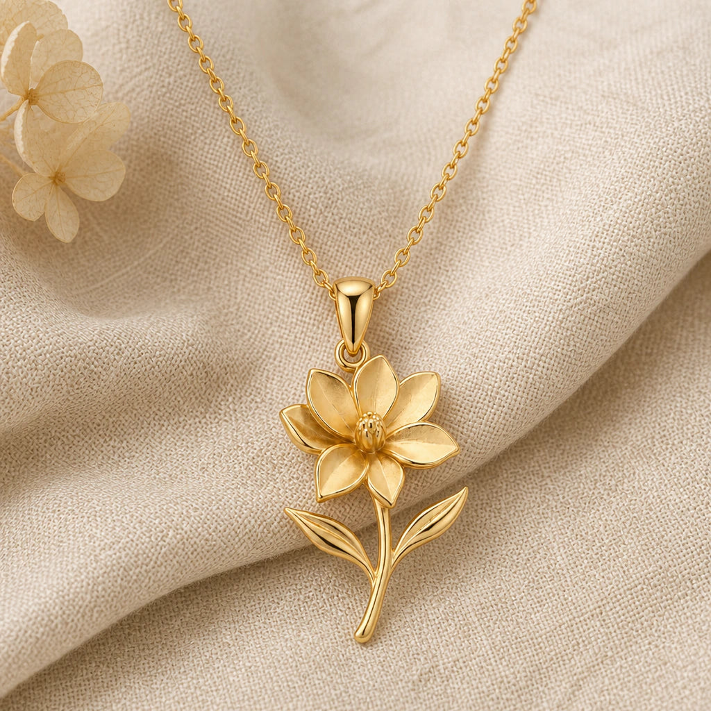 Magnolia Flower pendant necklace in a warm gold finish on cream fabric