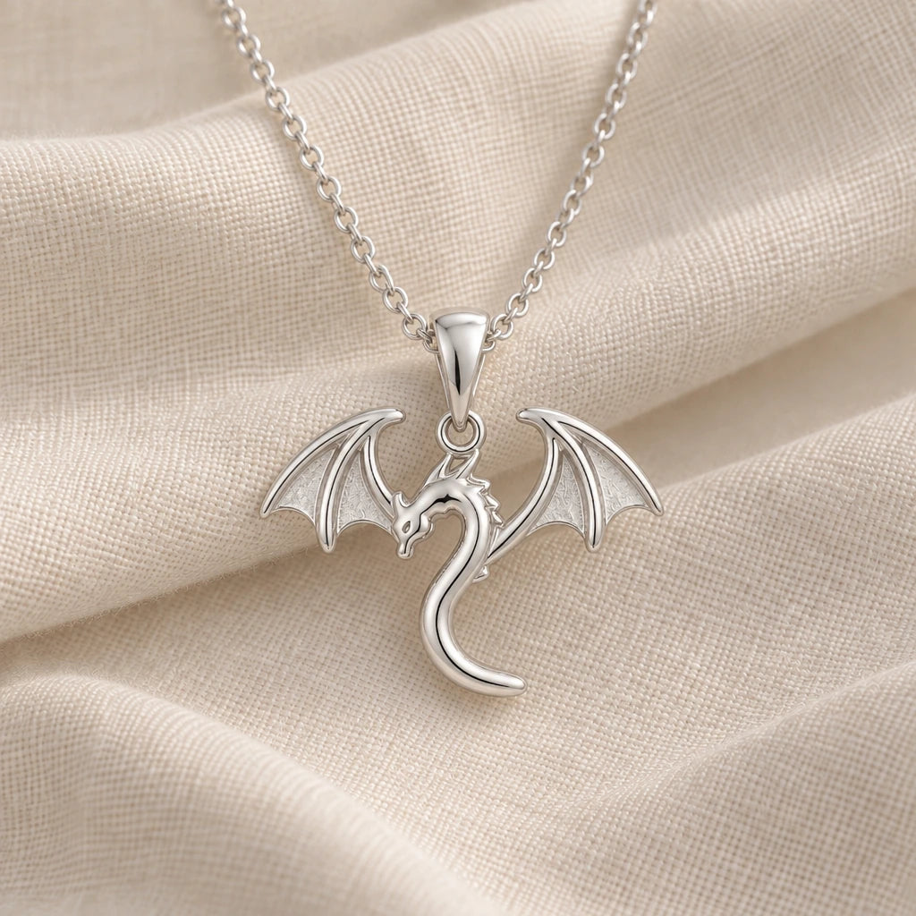 925 sterling silver tiny flying dragon pendant necklace on cream fabric