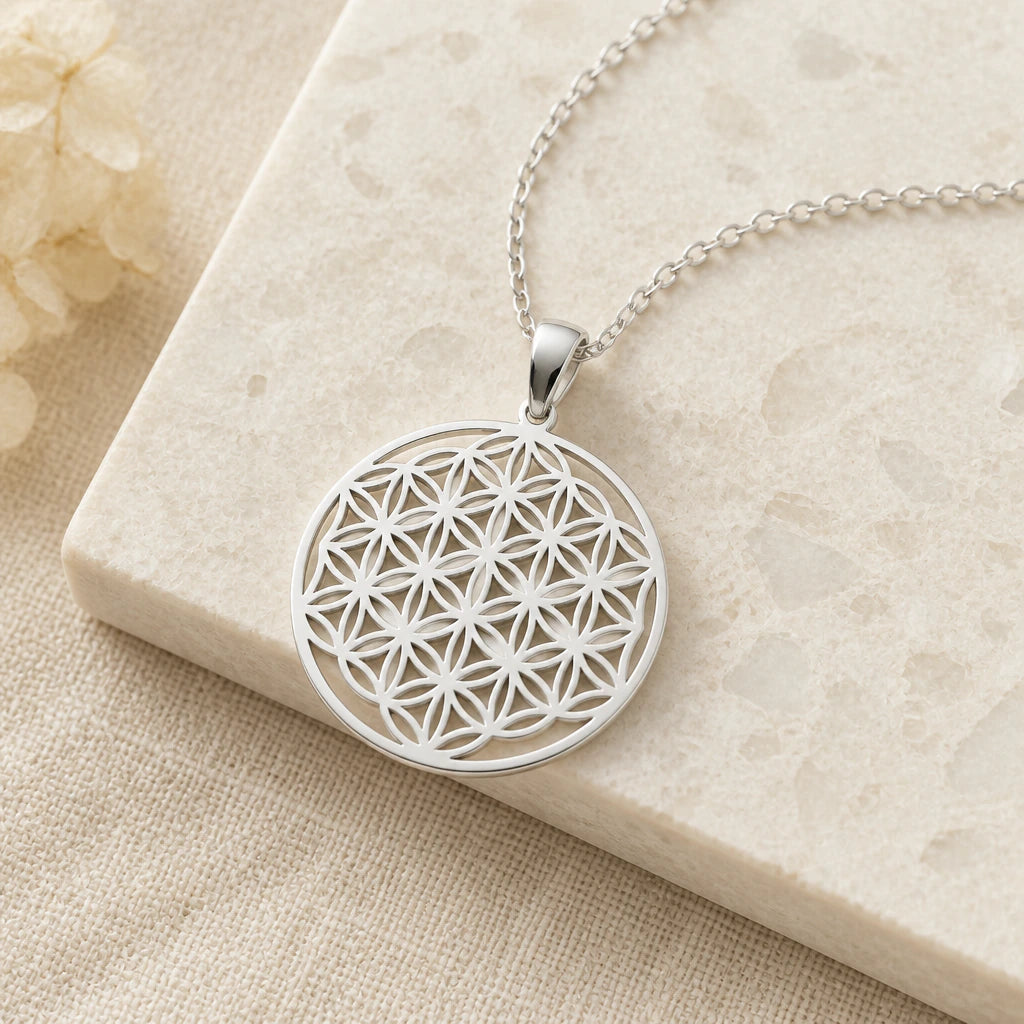 Close-up of silver flower of life pendant showing the sculpted detail