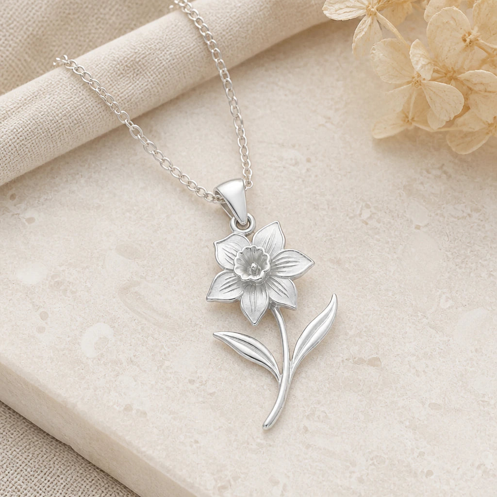 Close-up of silver daffodil flower pendant showing the sculpted detail