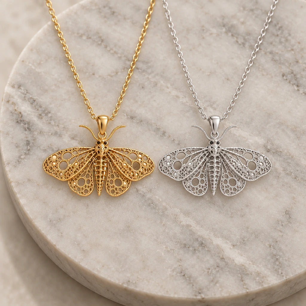 Fossil Moth Skeleton pendant necklace in silver and gold finishes side by side