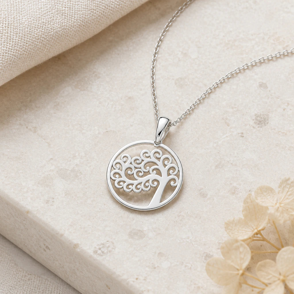 Close-up of silver tree of life circle pendant showing the sculpted detail