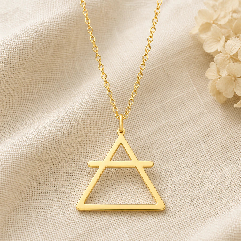 Air Element pendant necklace in a warm gold finish on cream fabric