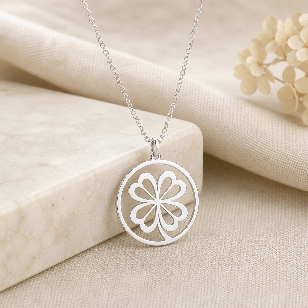925 sterling silver four leaf clover pendant necklace on softly folded cream linen