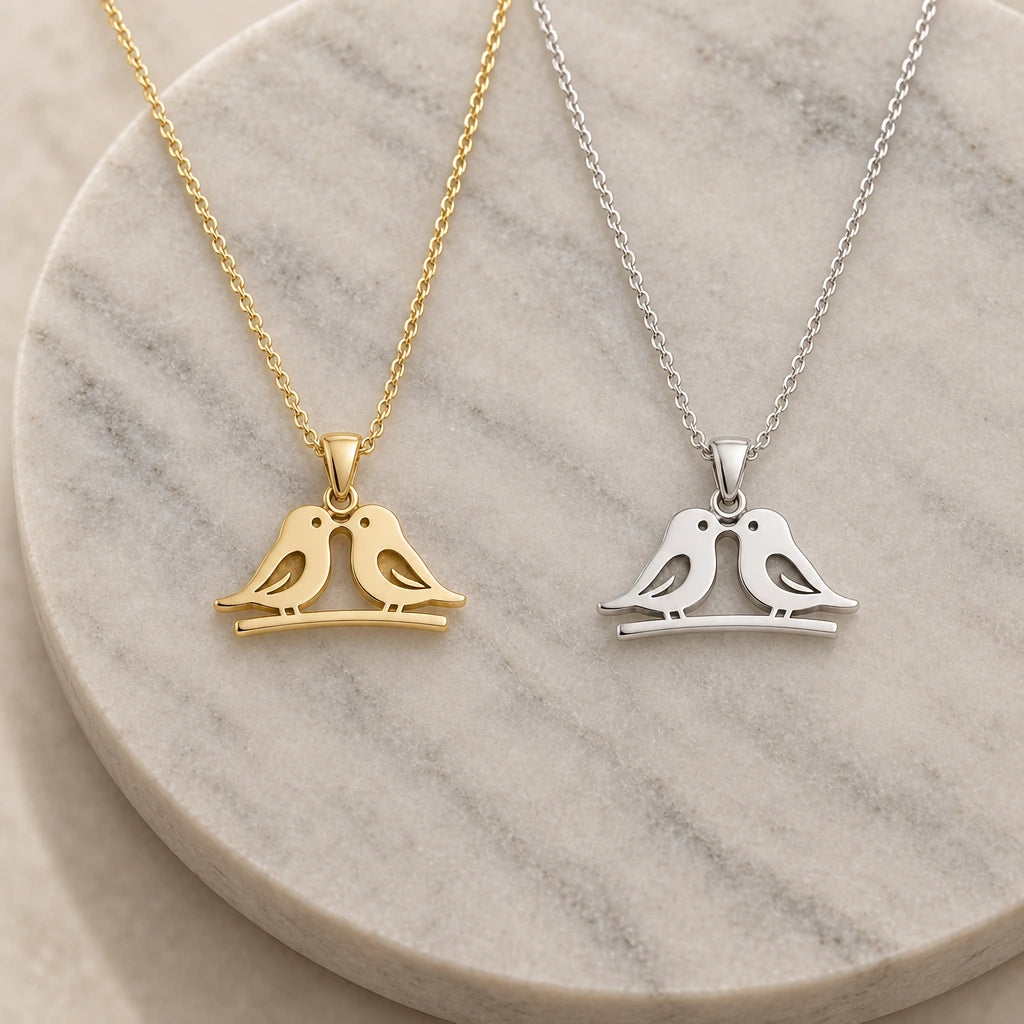 Love Birds pendant necklace in silver and gold finishes side by side