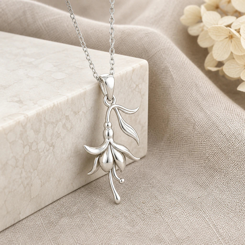 925 sterling silver fuchsia flower pendant necklace on softly folded cream linen