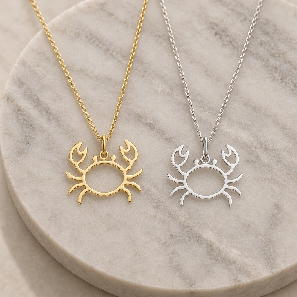 Crab Outline pendant necklace in silver and gold finishes side by side