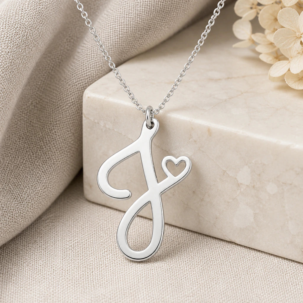 925 sterling silver j initial heart pendant necklace on softly folded cream linen