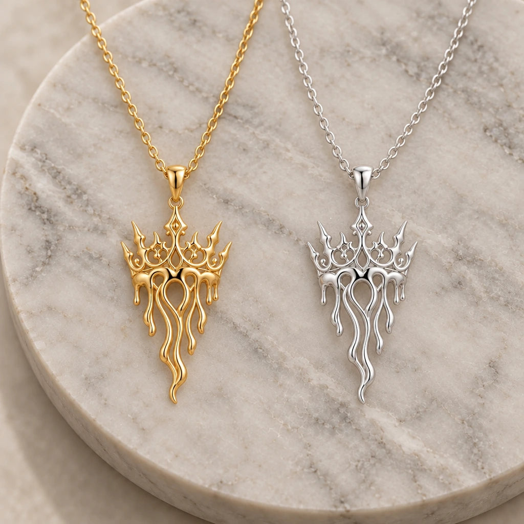 Crown Drift Melting Crown pendant necklace in silver and gold finishes side by side