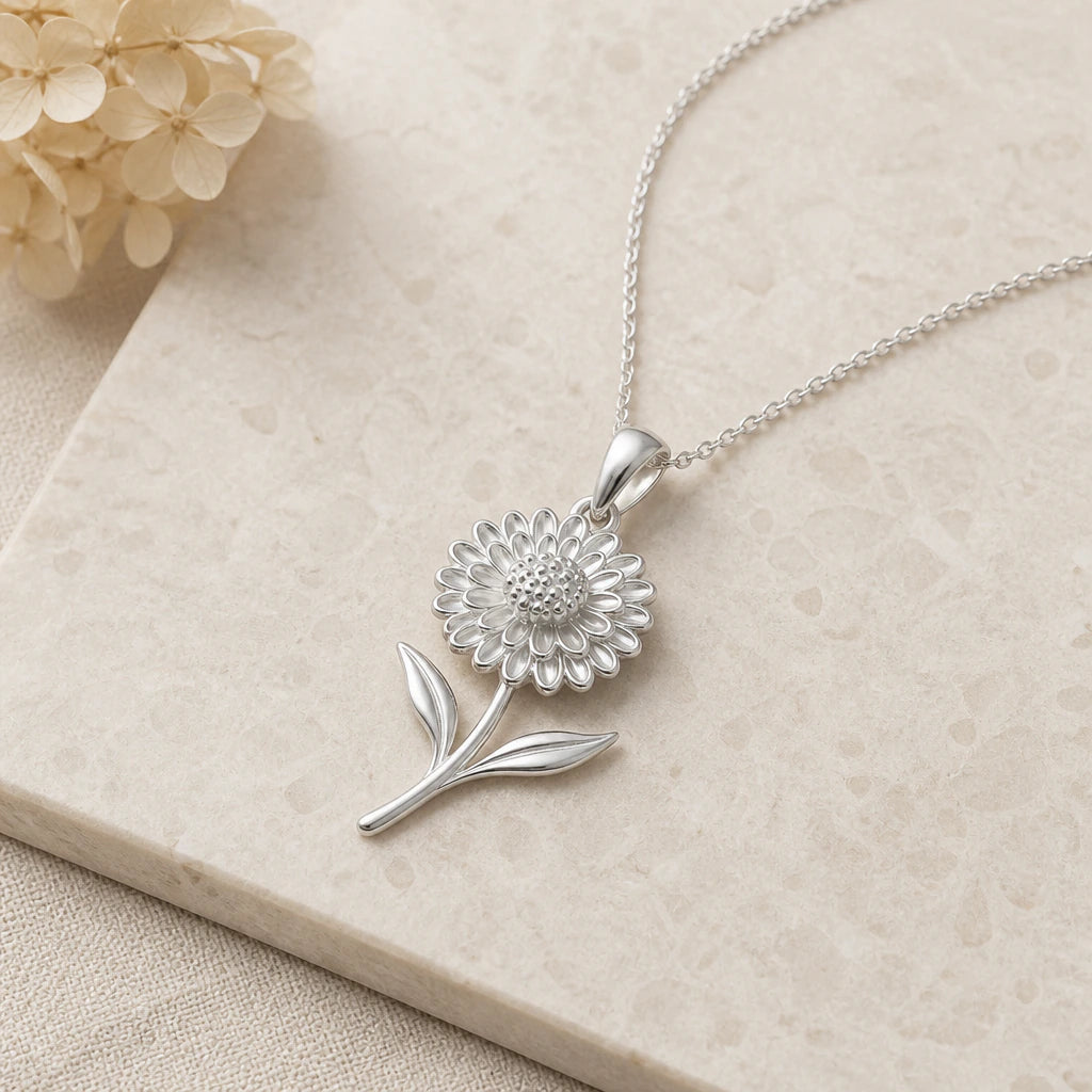 Close-up of silver chrysanthemum bloom flower pendant showing the sculpted detail