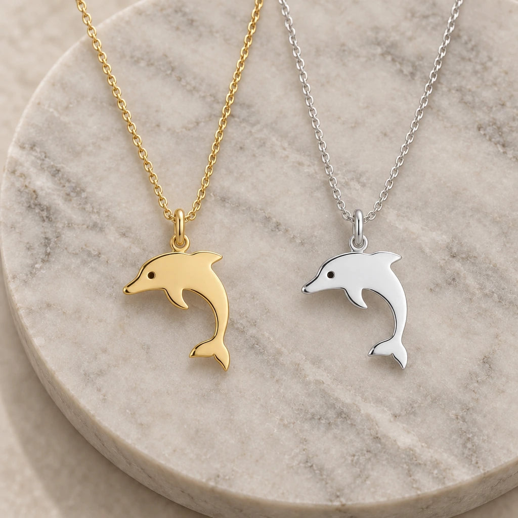 Dolphin Silhouette pendant necklace in silver and gold finishes side by side