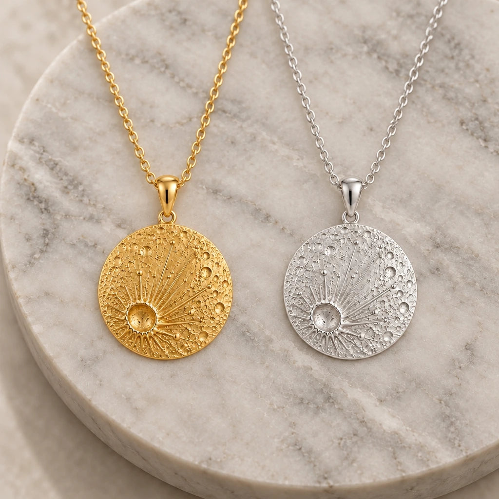 Lunar Impact Crater pendant necklace in silver and gold finishes side by side