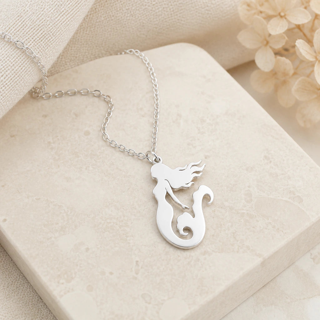 Close-up of silver mermaid pendant showing the sculpted detail
