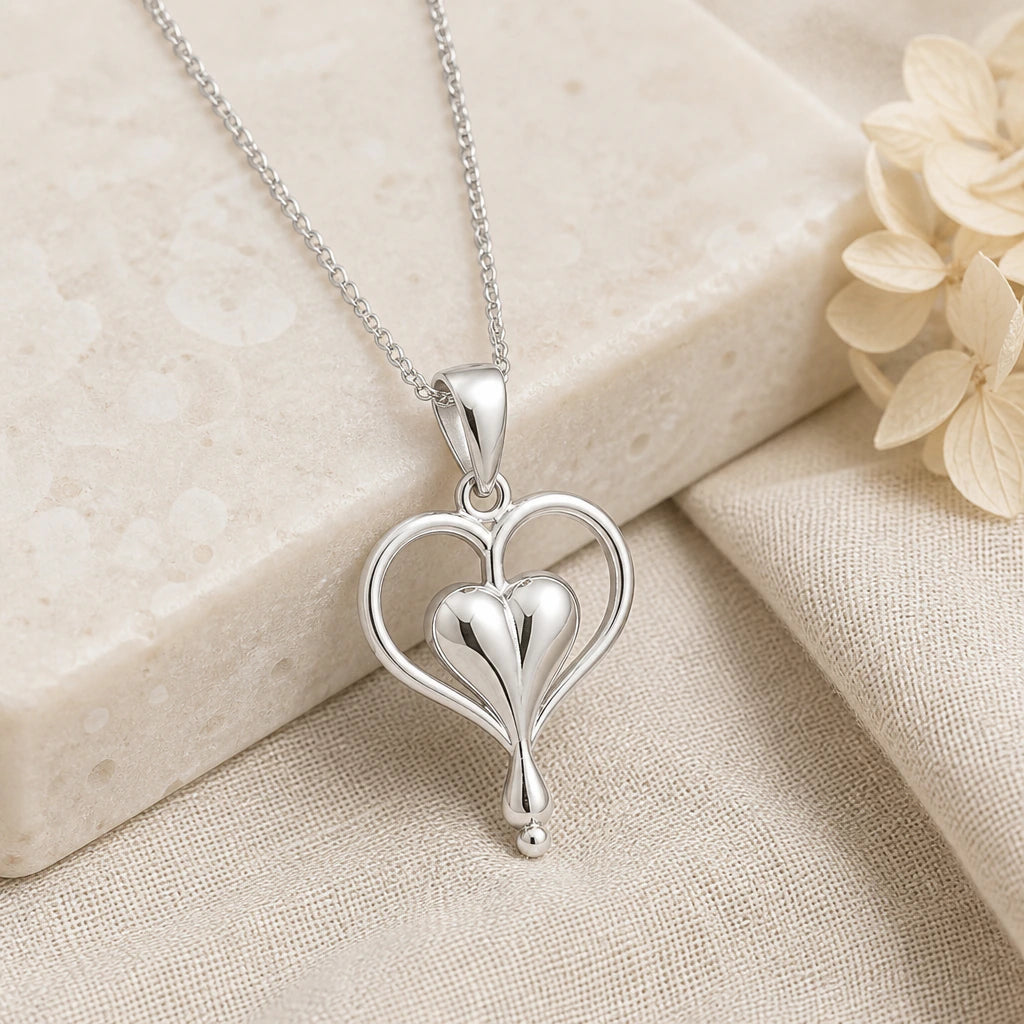 925 sterling silver bleeding heart flower pendant necklace on softly folded cream linen