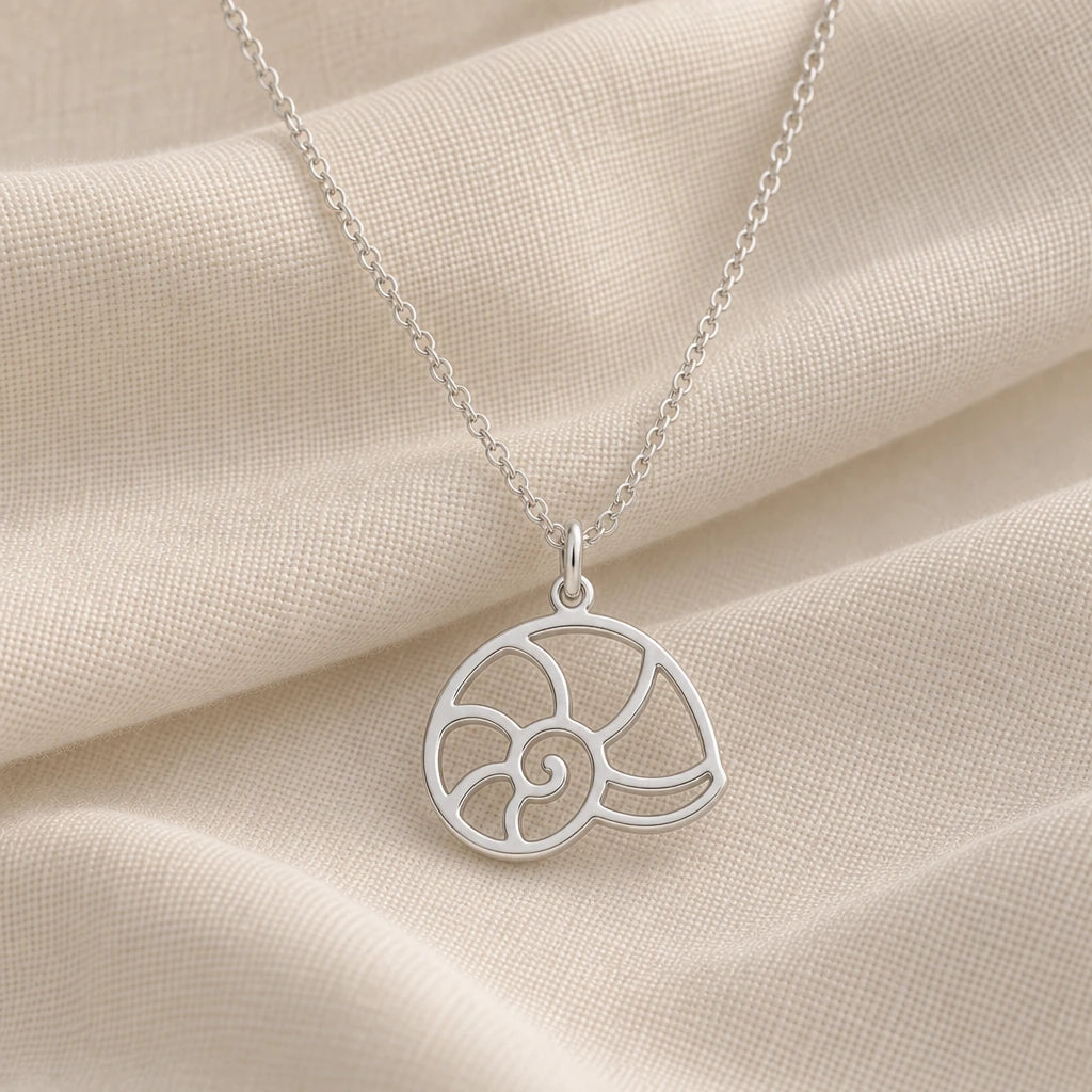 925 sterling silver nautilus shell pendant necklace on cream fabric