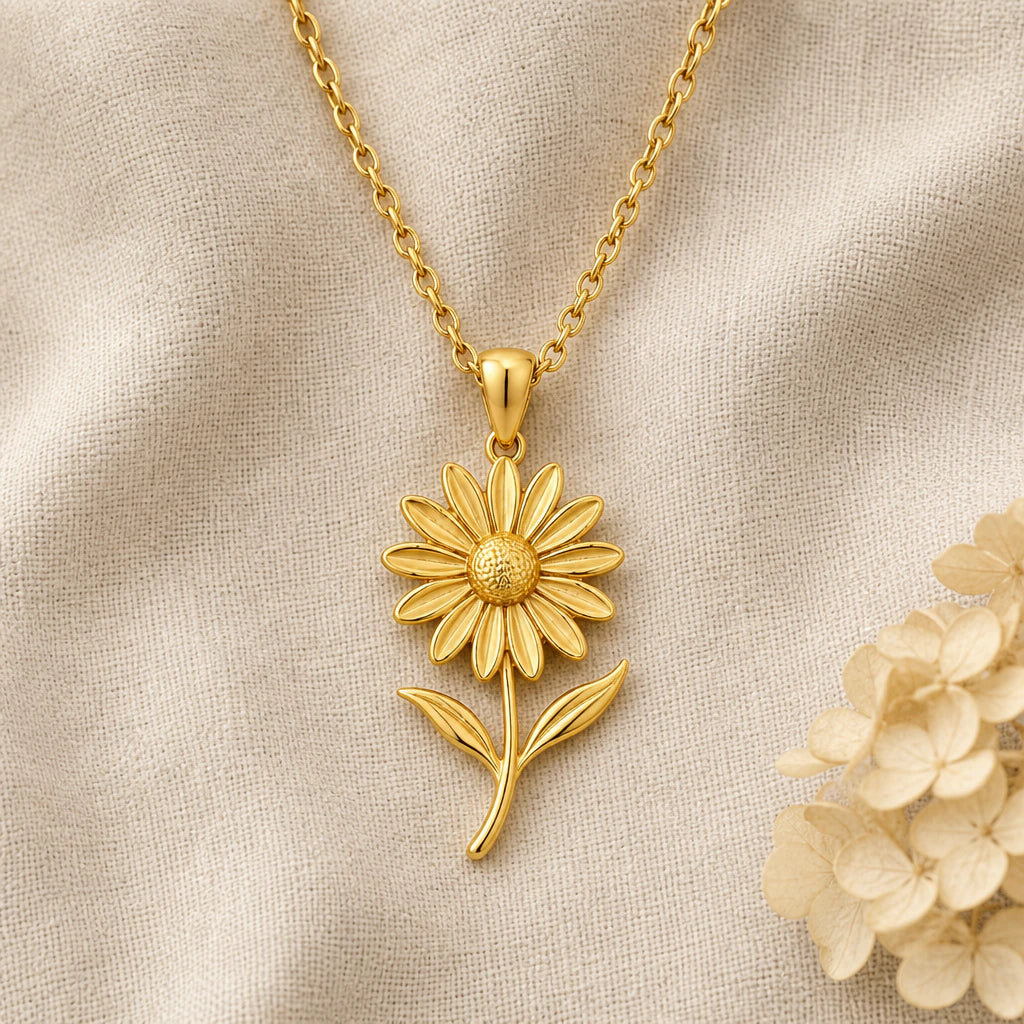 Black Eyed Susan Flower pendant necklace in a warm gold finish on cream fabric