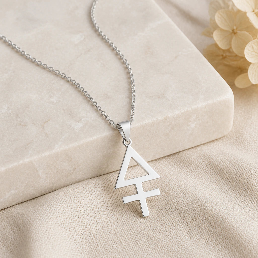 Close-up of silver sulphur alchemy symbol pendant showing the sculpted detail