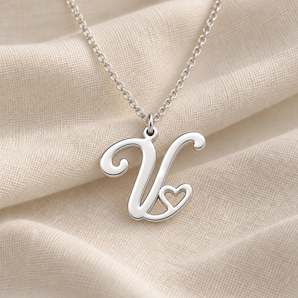 925 sterling silver v initial heart pendant necklace on softly folded cream linen