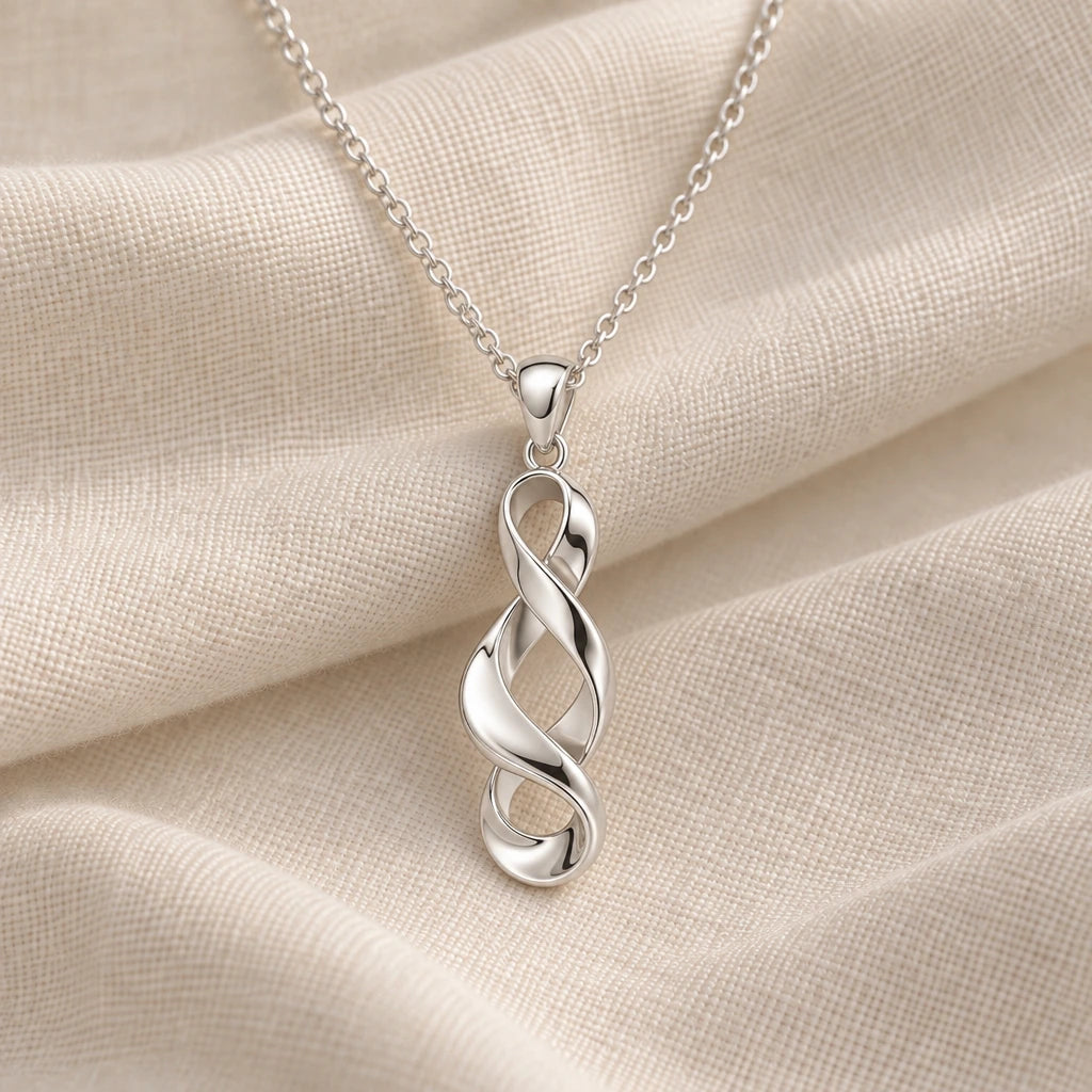 925 sterling silver sculptural twisted ribbon pendant necklace on cream fabric