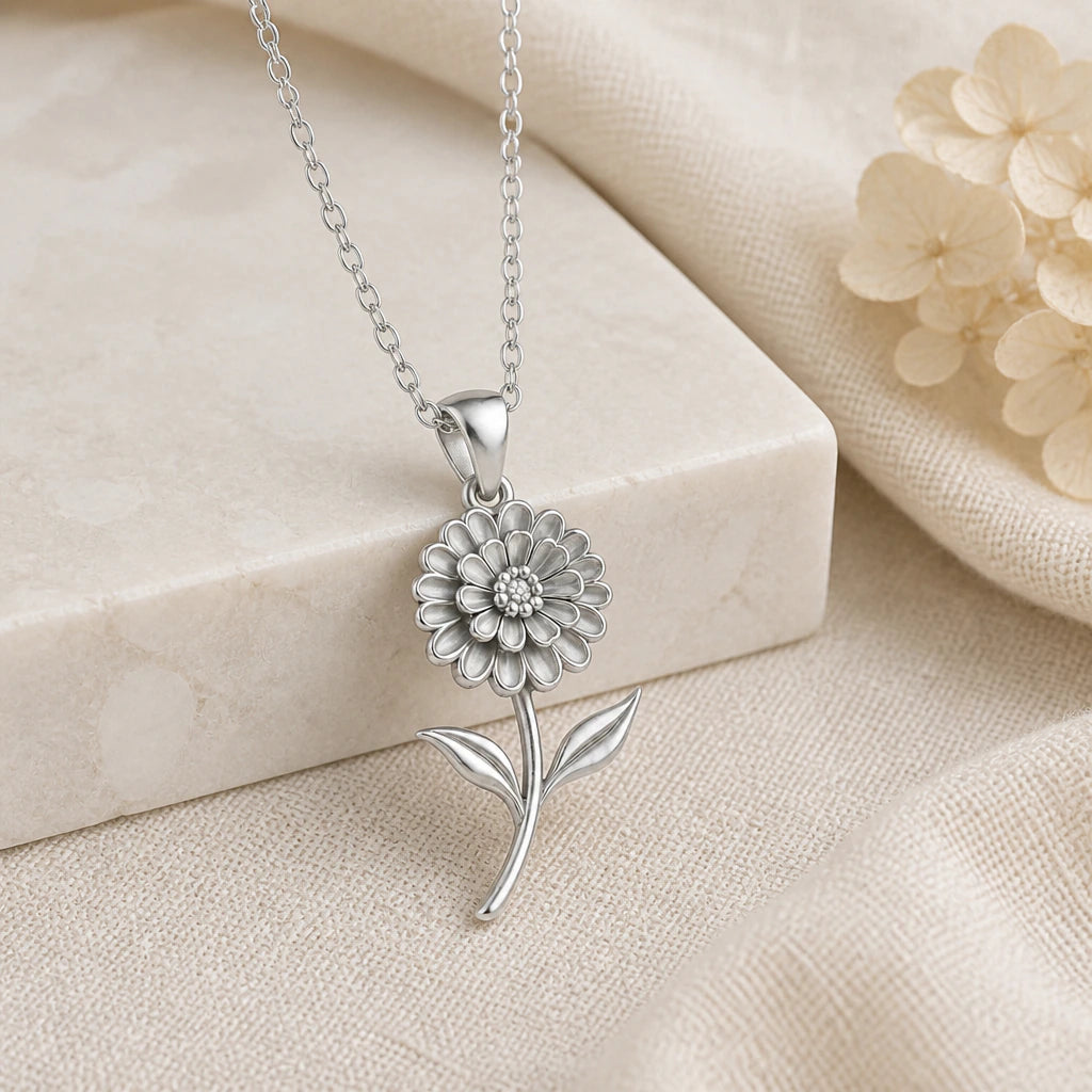 925 sterling silver zinnia flower pendant necklace on softly folded cream linen