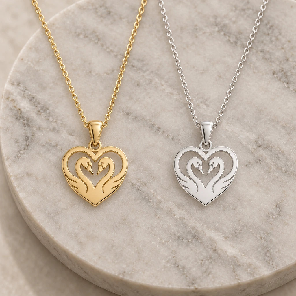 Heart Swan pendant necklace in silver and gold finishes side by side