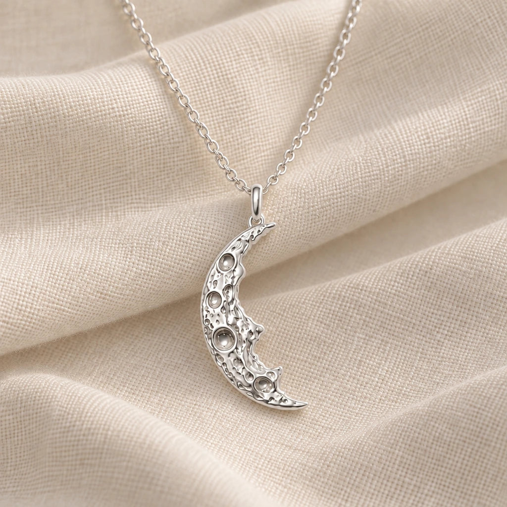 925 sterling silver cratered moon fragment pendant necklace on cream fabric