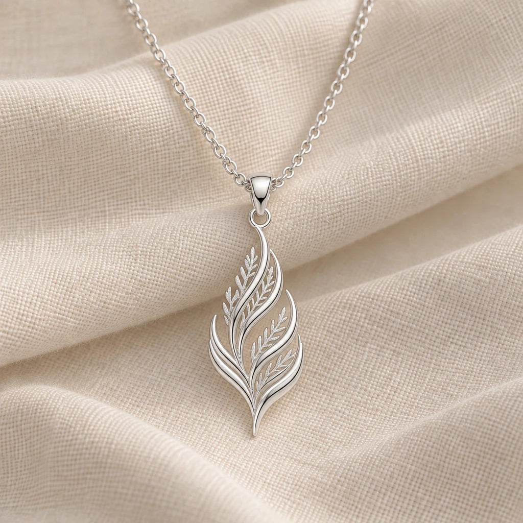 925 sterling silver cedar flame fronds pendant necklace on cream fabric