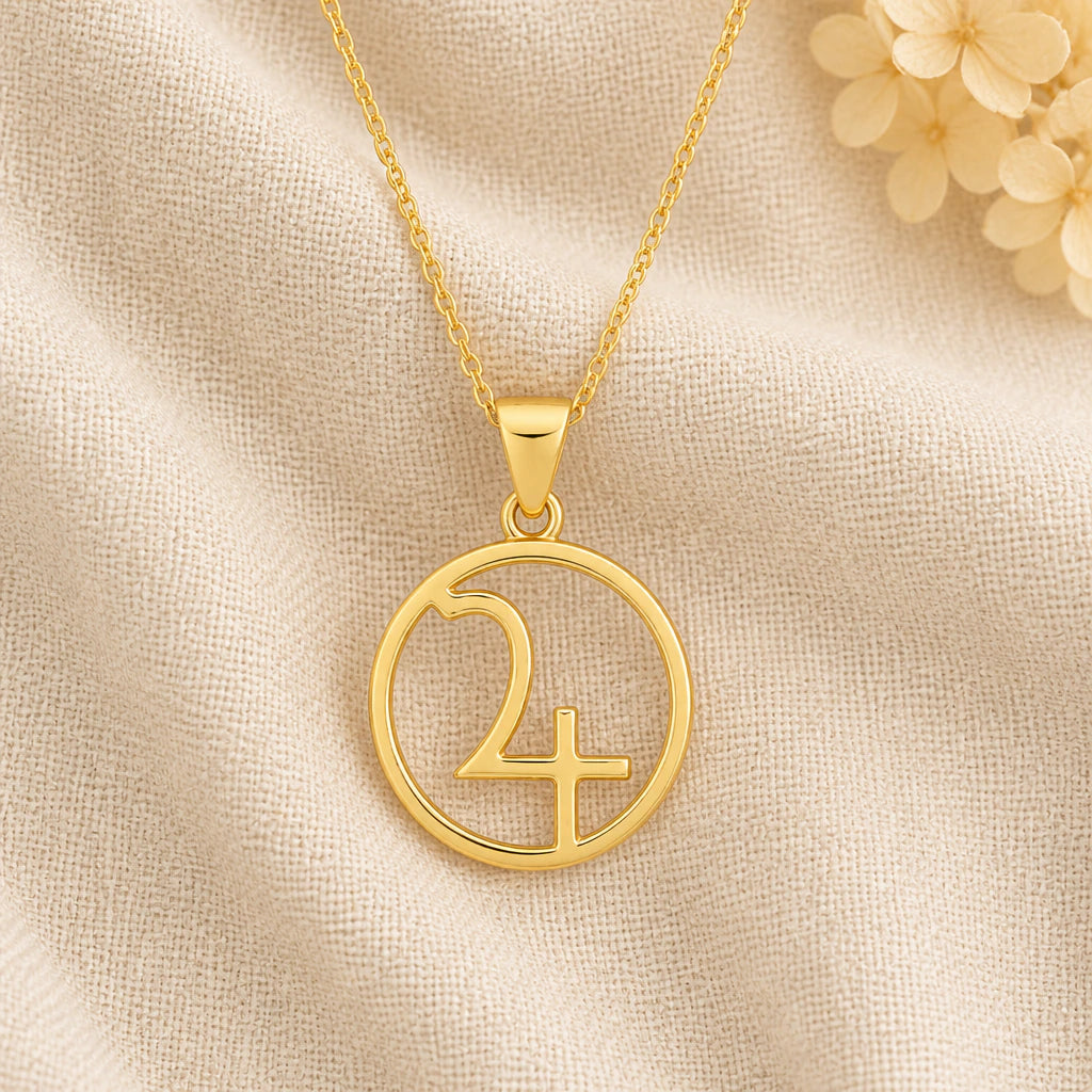 Jupiter Symbol pendant necklace in a warm gold finish on cream fabric