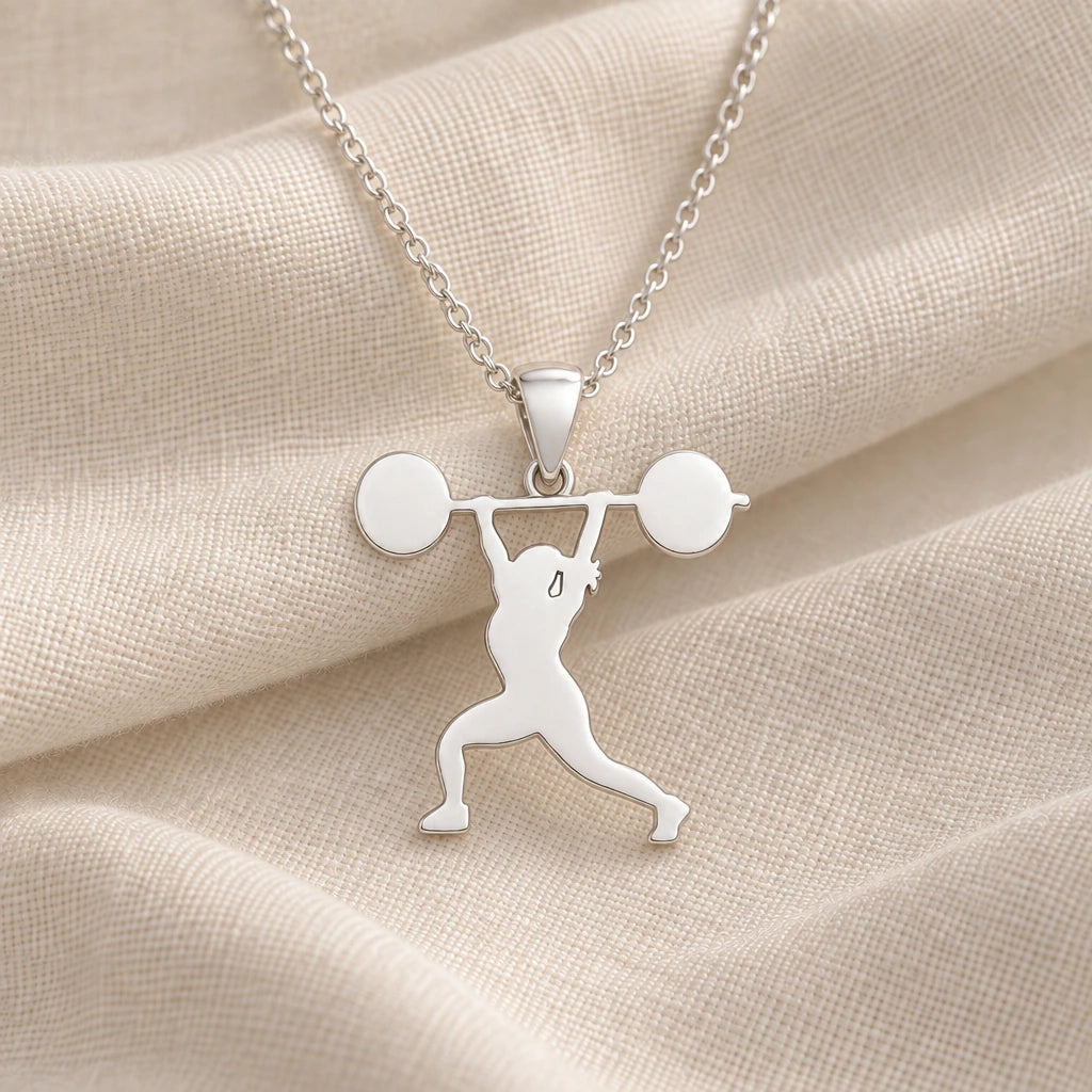 925 sterling silver weightlifter overhead press pendant necklace on cream fabric
