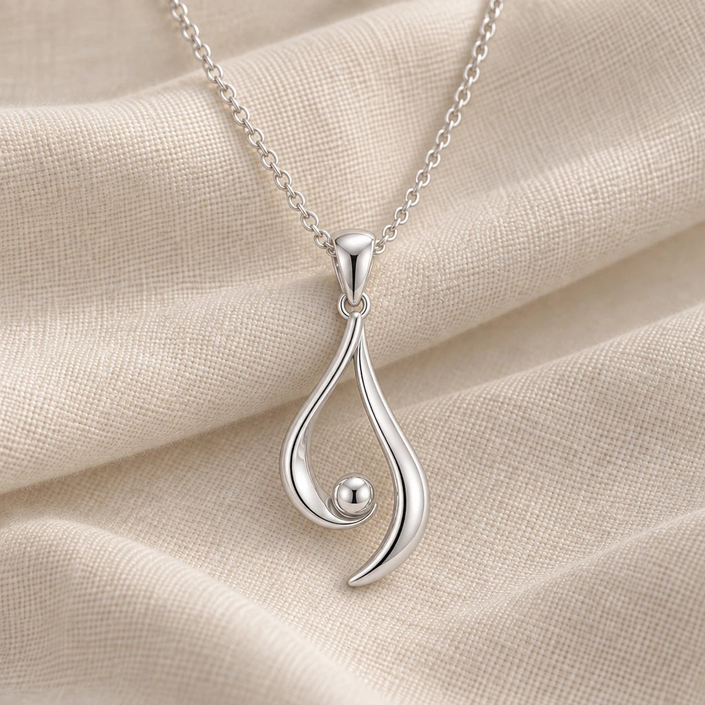925 sterling silver asymmetrical aura pendant necklace on cream fabric