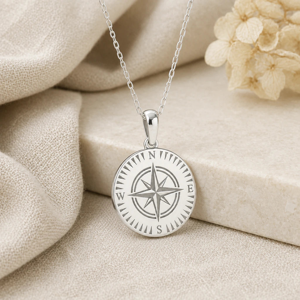 925 sterling silver compass pendant necklace on softly folded cream linen