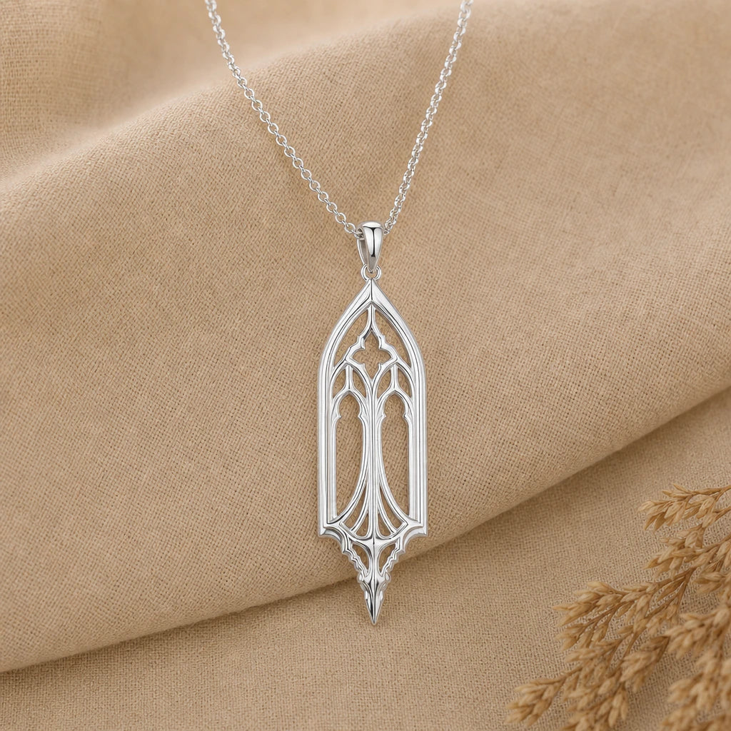 Close-up of silver gothic window pendant with twin lancets and tracery