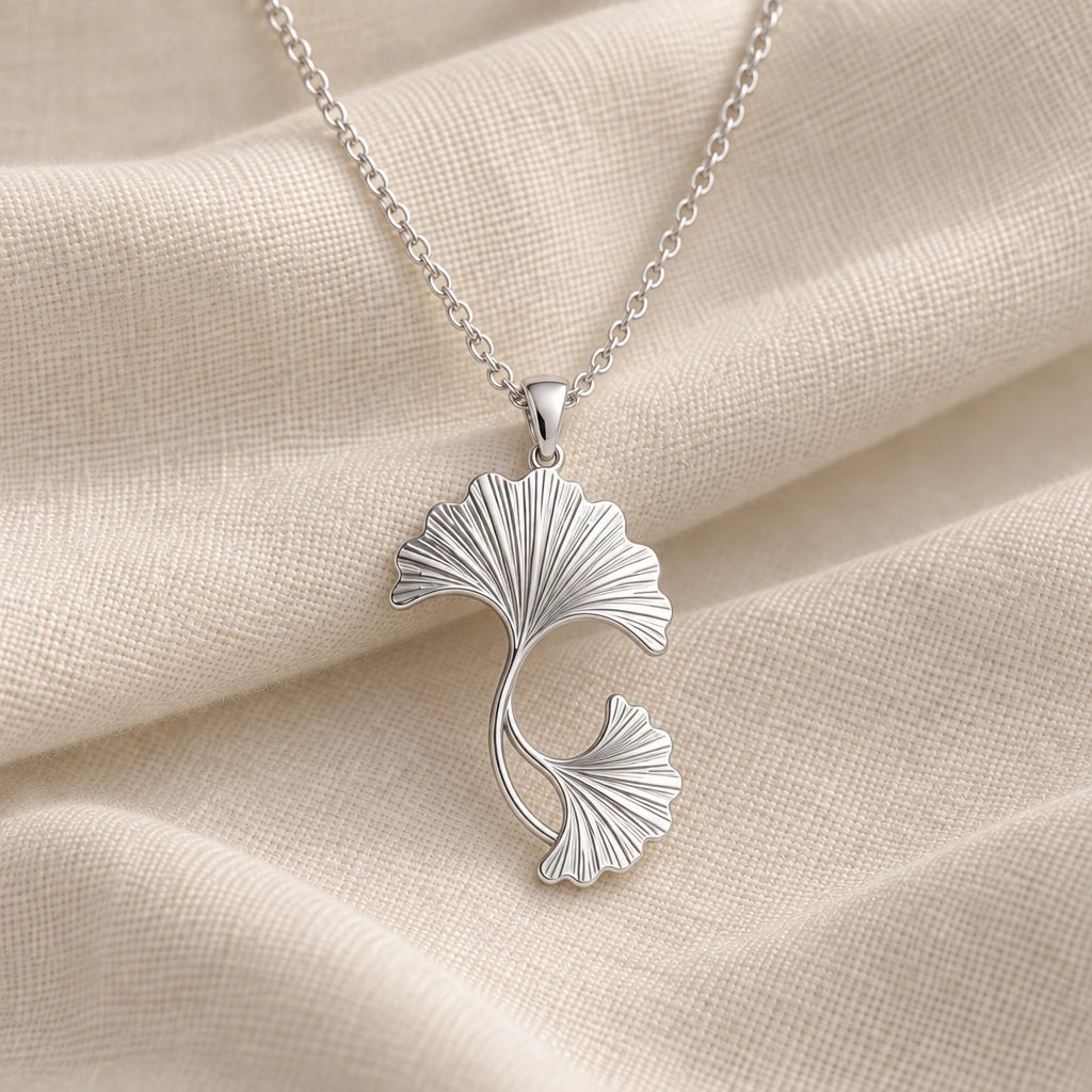 925 sterling silver ginkgo fan leaves pendant necklace on cream fabric