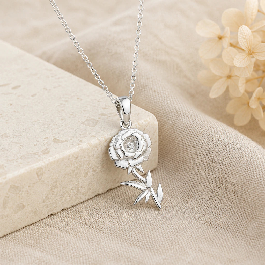 925 sterling silver marigold flower pendant necklace on softly folded cream linen