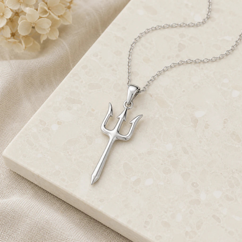 Close-up of silver trident pendant showing the sculpted detail