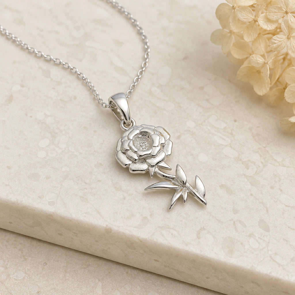 Close-up of silver marigold flower pendant showing the sculpted detail